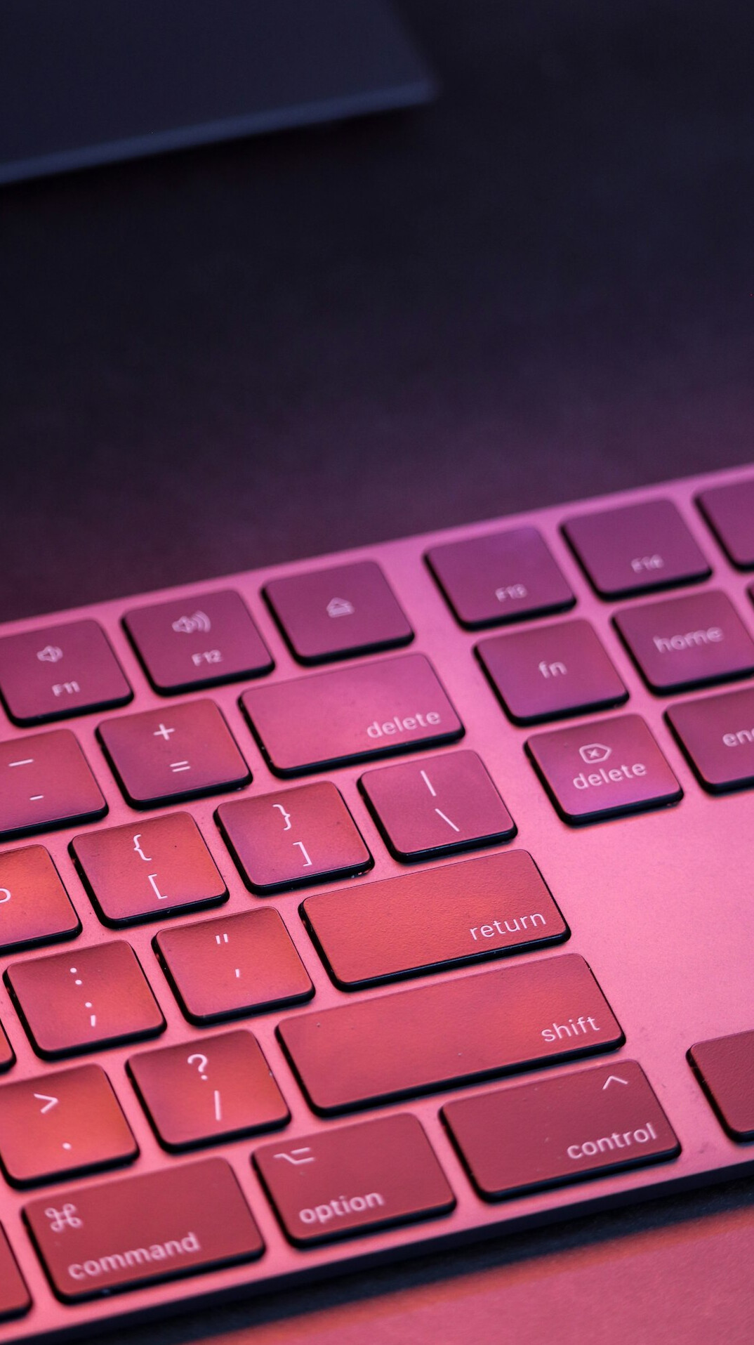 Close-up of a developer's hands typing code on a laptop keyboard